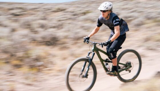A student rides his bike down Becks during the new student orientation bike trip.