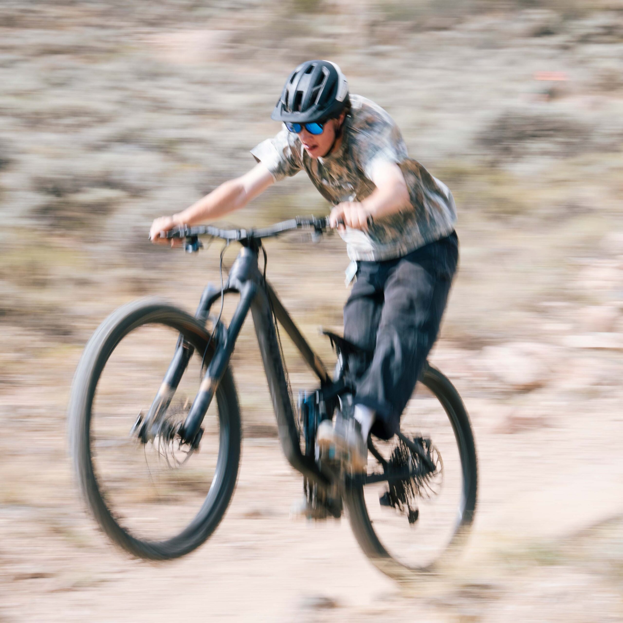 A student pops a wheelie while riding his bike down Becks during the new student orientation bike trip.