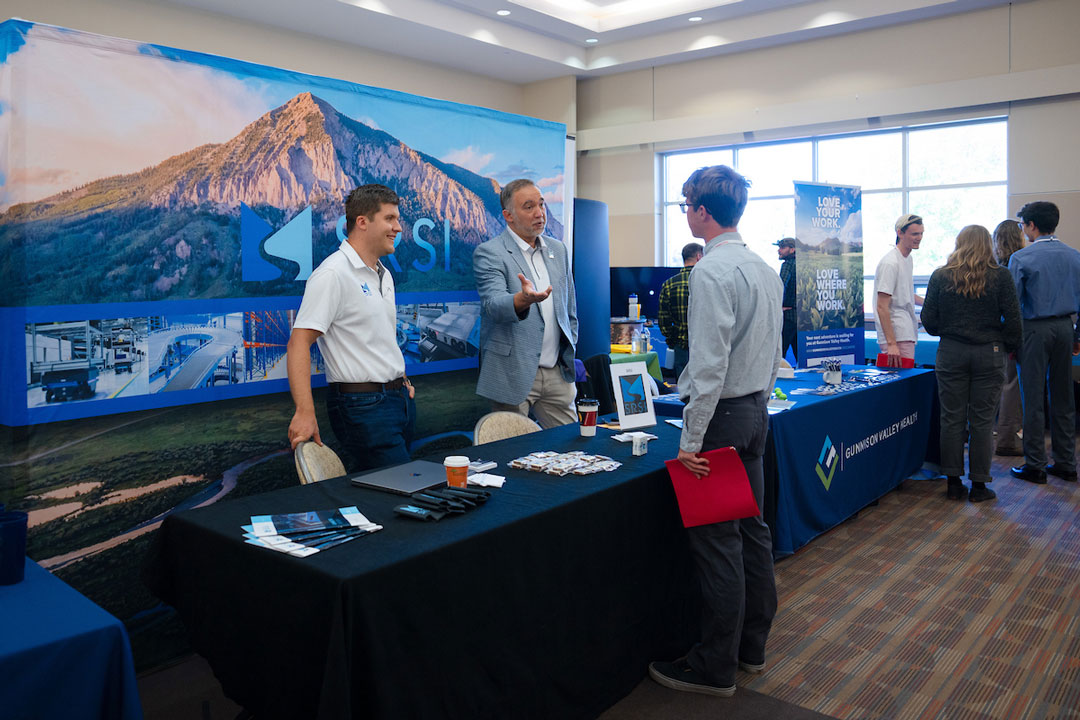 A student talks with an employer during a career and internship fair.