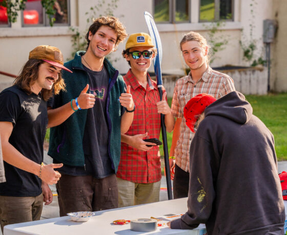 Four students smile for a group photo while tabling for the Whitewater Club at the Taste of Western club fair.