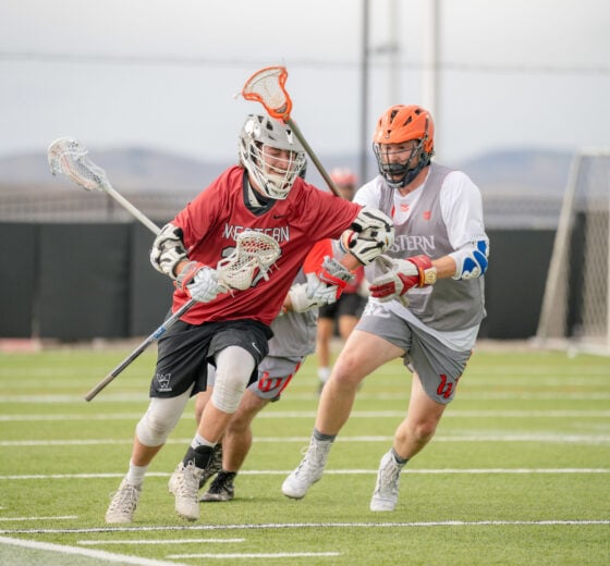 Two Western Club Sports lacrosse athletes play on Katy O. Rady Field.