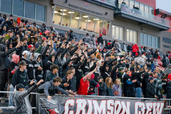 Fans in the student section hold their arms out to try to catch a "Bring Your Mojo" t-shirt.
