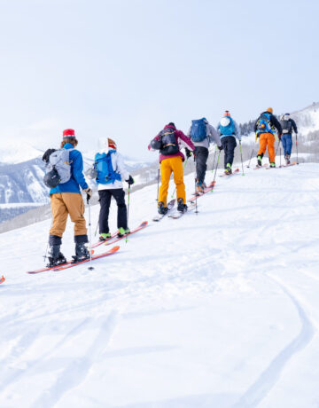 A large group from a Recreation & Outdoor Education class skins up Snodgrass Mountain in single file.