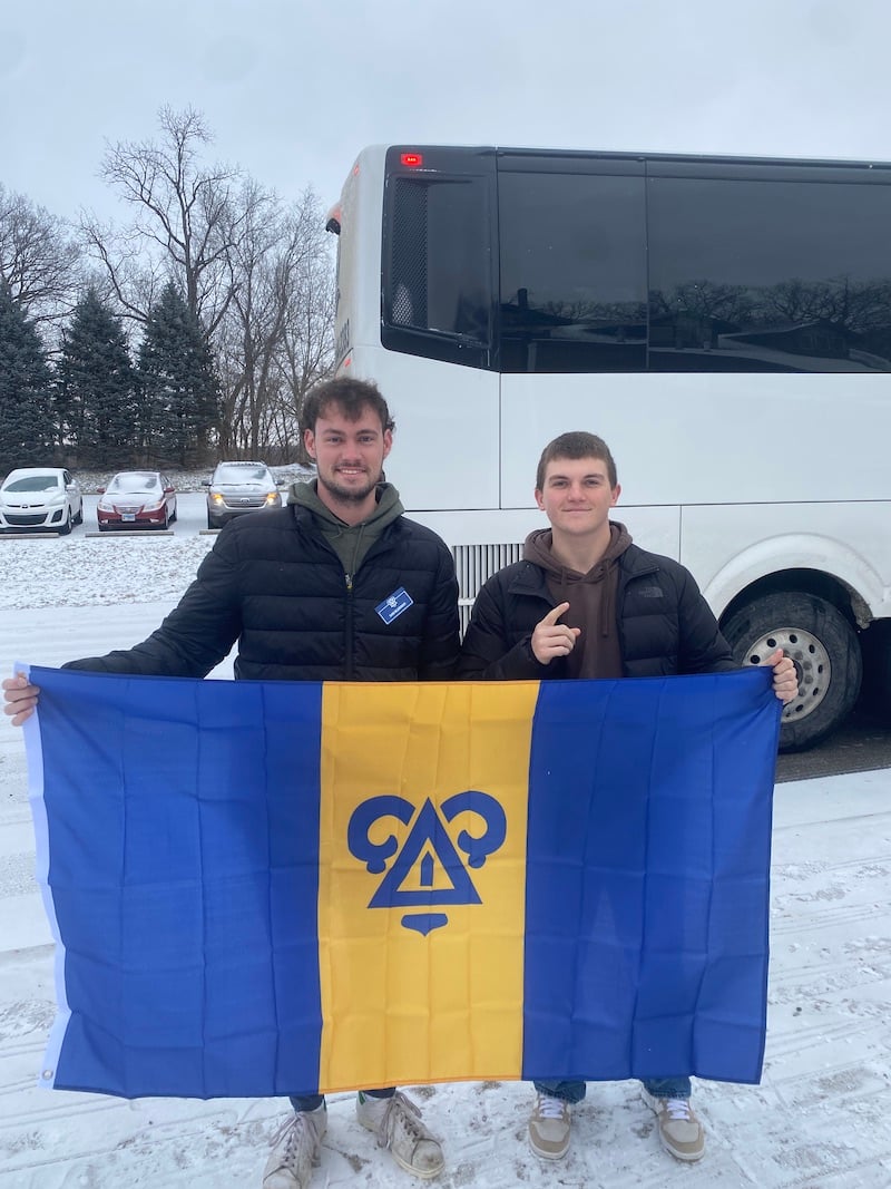 The DU founders pose together with their banner.