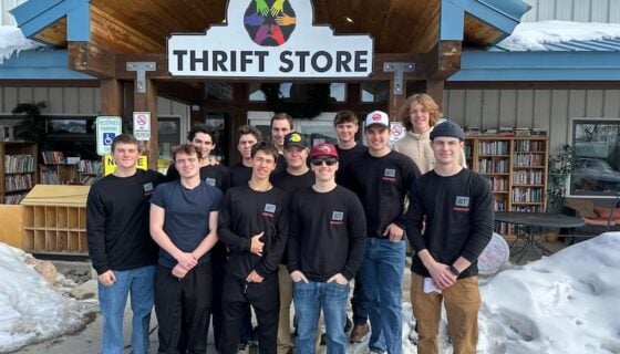 Delta Upsilon poses for a group shot outside of Six Points Thrift Store.