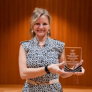 Autumn Rosengren poses for a photo with her award at the 2026 Distinguished Achievement in Graduate Studies ceremony.