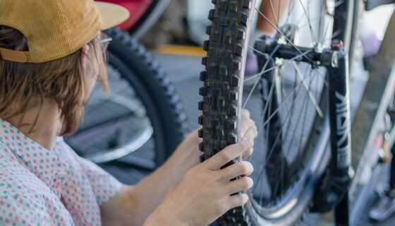 A student intern puts sensors on a mountain bike wheel