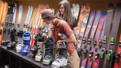 An outdoor inudstry MBA student and faculty member look at ski boots in the Blister Review show room