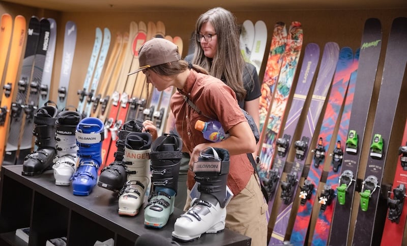 An outdoor inudstry MBA student and faculty member look at ski boots in the Blister Review show room
