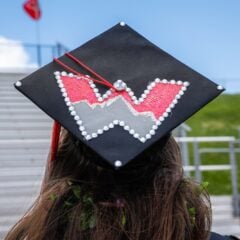 A Western grad shows off her cap decorated with a Western W