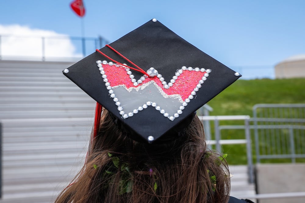A Western grad shows off her cap decorated with a Western W
