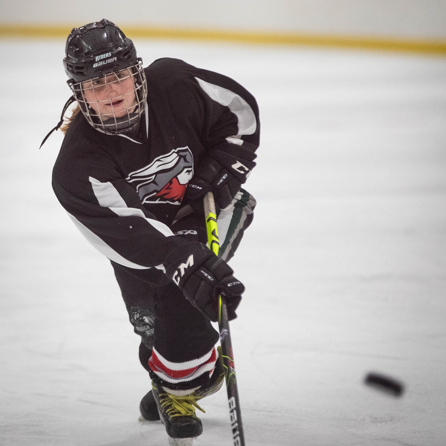 A Western women's hockey player shoots the puck and scores a goal.