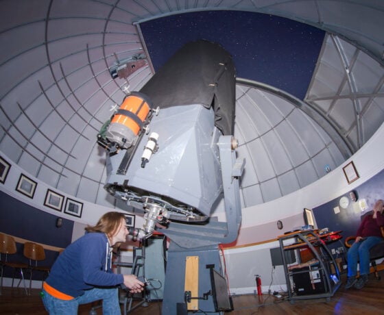 Zeth Palmer looks through the main telescope at the Gunnison Valley Observatory.