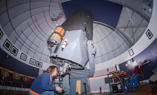 Zeth Palmer looks through the main telescope at the Gunnison Valley Observatory.