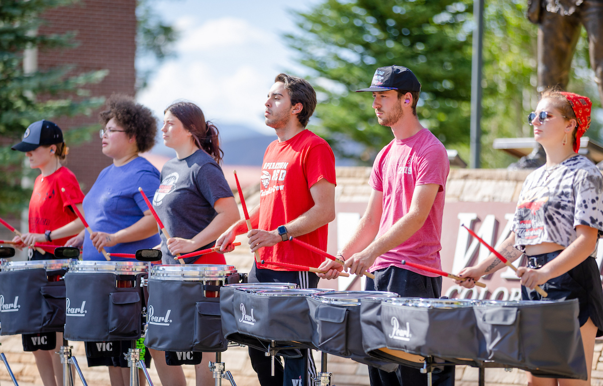 The drumline performs in front of the Welcome Center