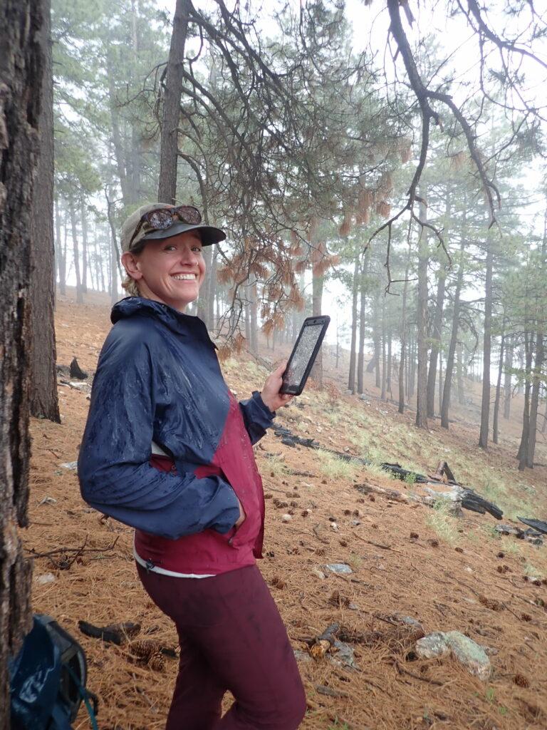 Emma using a device to study a forest