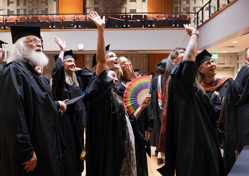 GPCW graduates in caps and gowns wave to friends and family at the 2025 graduation ceremony.