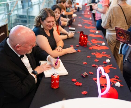 Kevin Anderson and other authors sign books for attendees at the GPCW publishing event.