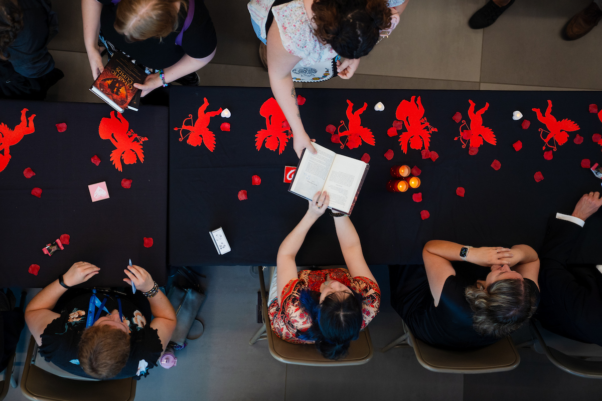 Authors sign books for attendees at the GPCW publishing event.