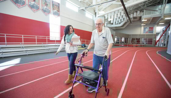 Aspen walks with Bernie Goldberg during a six minute walk test as a part of Wellness Elevated.
