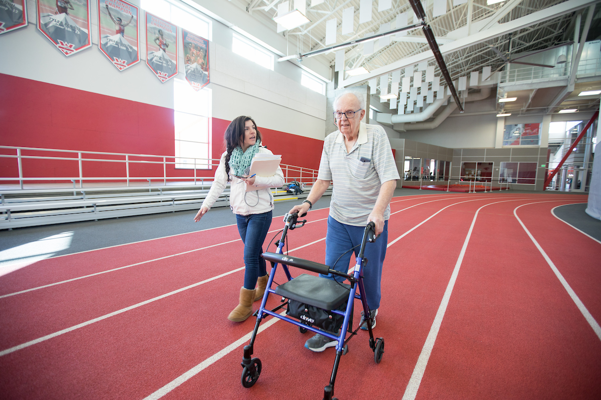 Aspen walks with Bernie Goldberg during a six minute walk test as a part of Wellness Elevated.