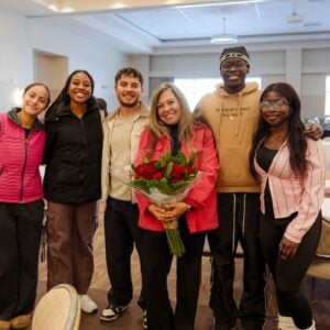 A group photo of Sally with students during her retirement party.