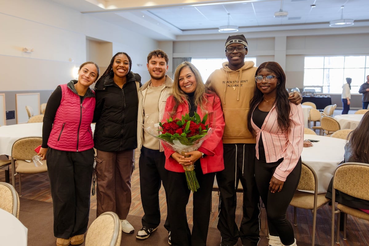 A group photo of Sally with students during her retirement party.