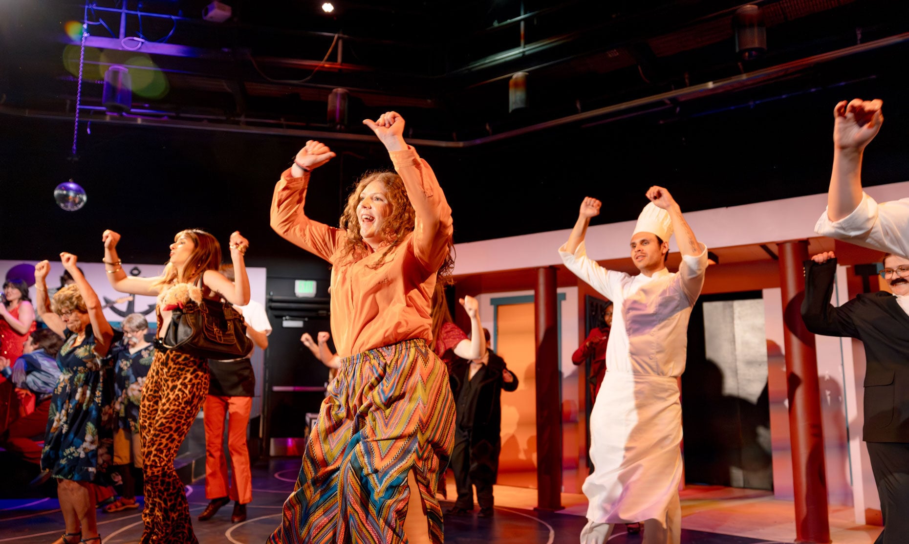 Student actors break into dance during Disaster! The Musical.