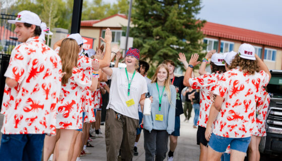 First-year students are greeted by orientation leaders as they enter the Mountaineer Bowl.