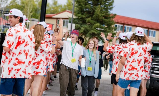 First-year students are greeted by orientation leaders as they enter the Mountaineer Bowl.