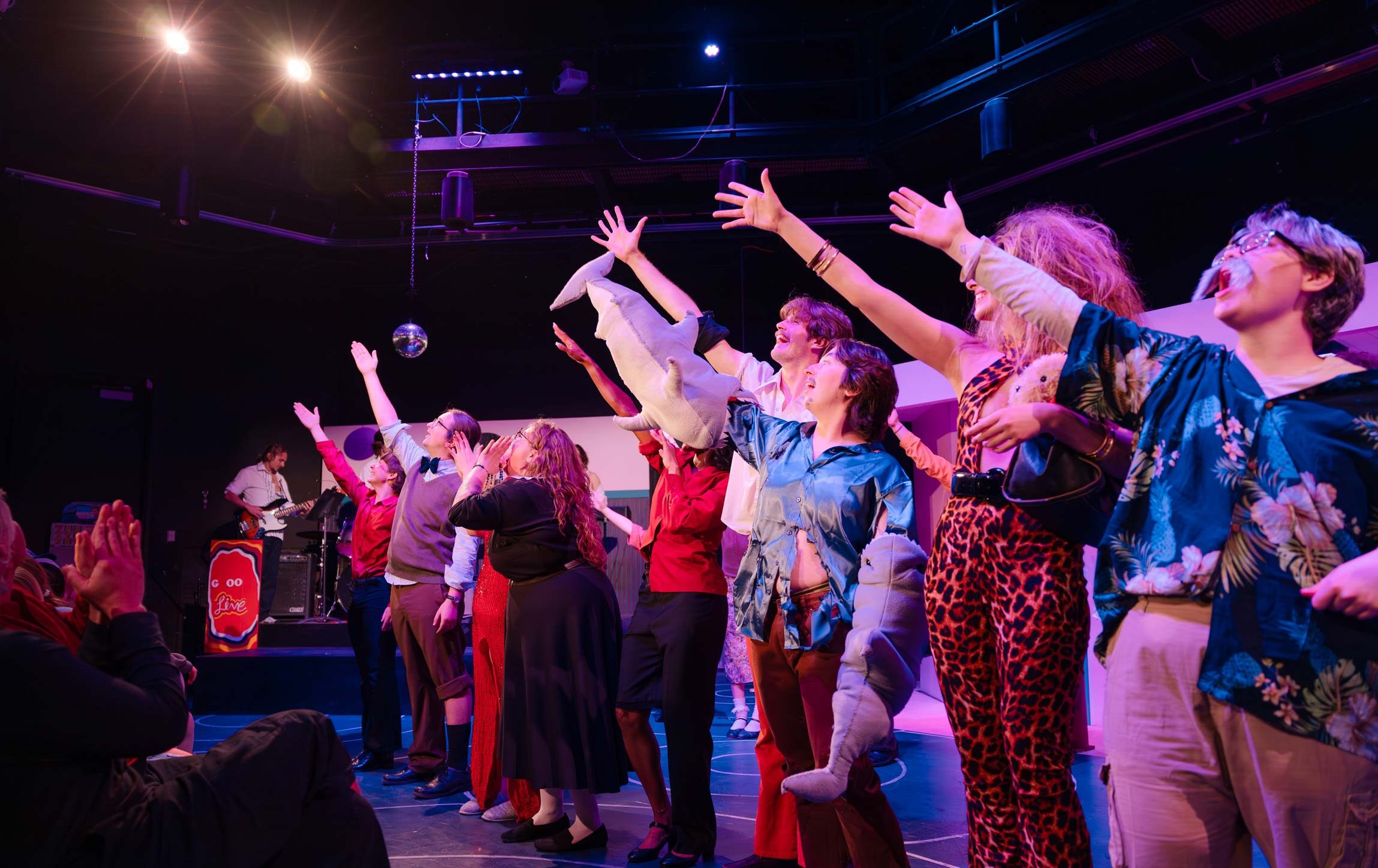 Students salute the light techs at the end of Disaster! The Musical.