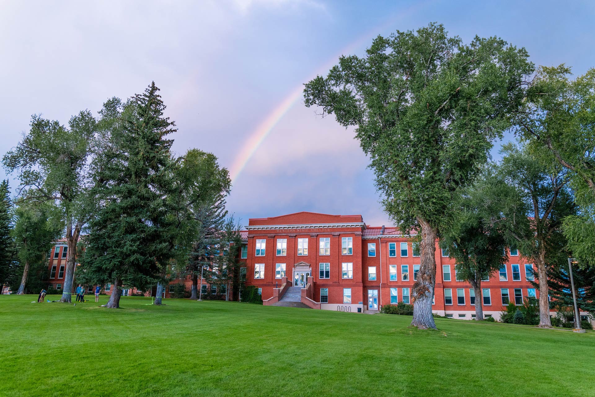 A rainbow is seen above Taylor Hall at sunset