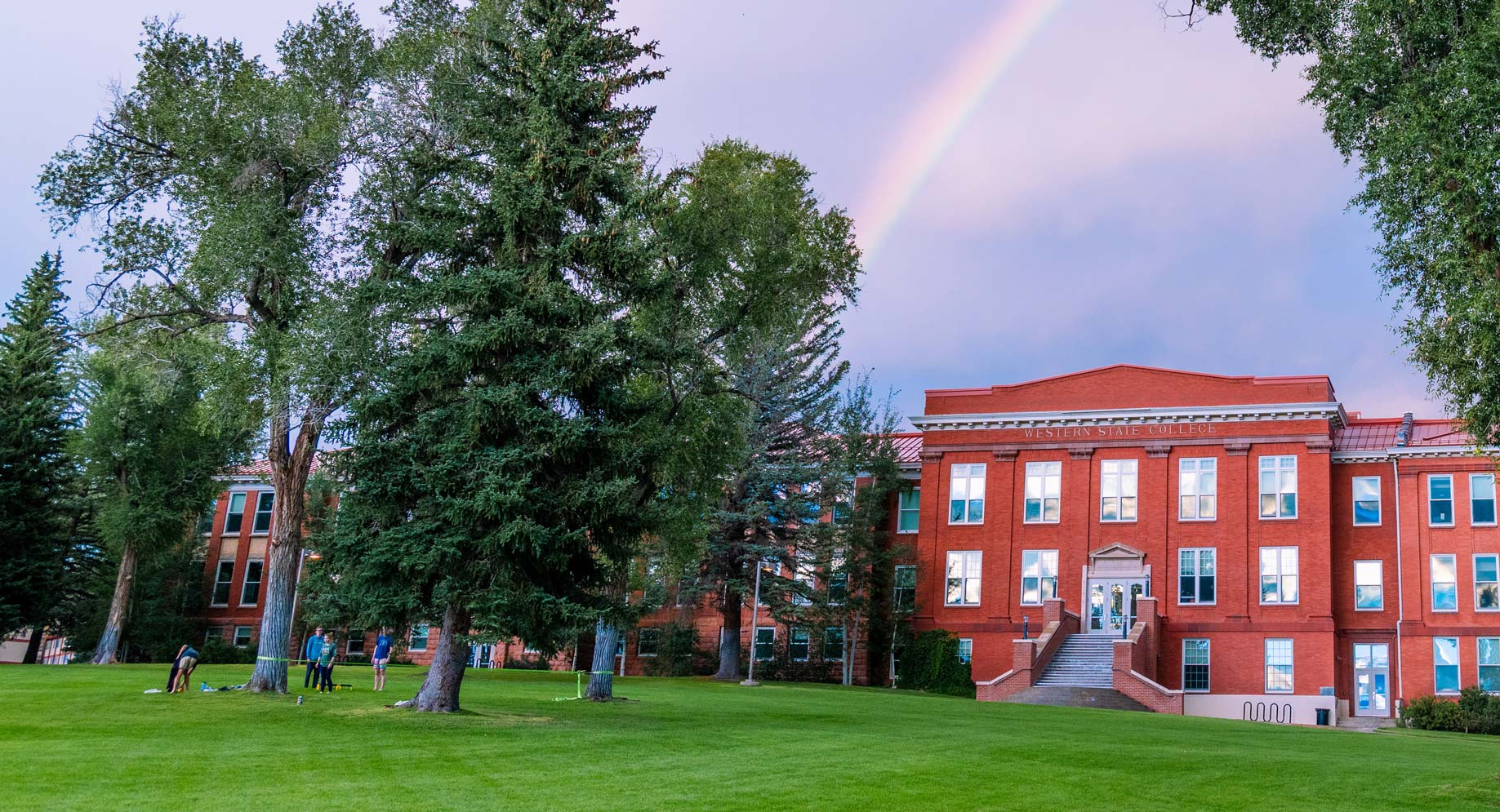 A rainbow is seen above Taylor Hall at sunset