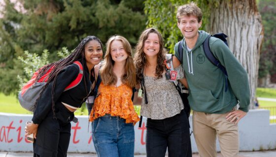 Four students gather for a group photo on their way to class.