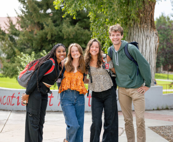 Four students gather for a group photo on their way to class.
