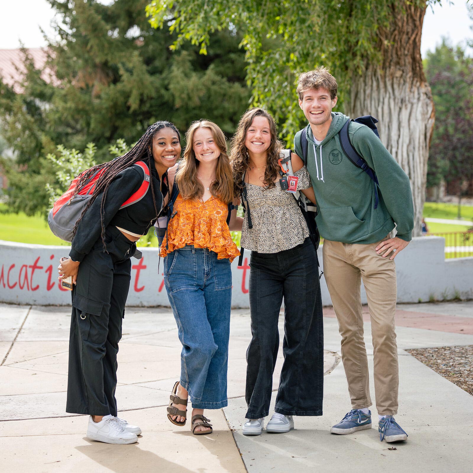 Four students gather for a group photo on their way to class.