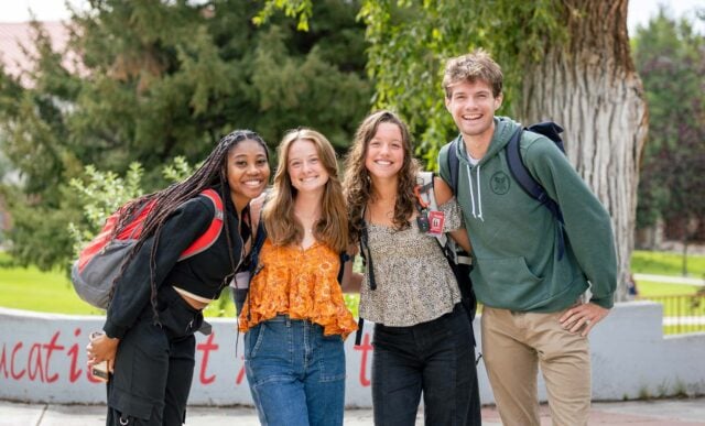 Four students gather for a group photo on their way to class.