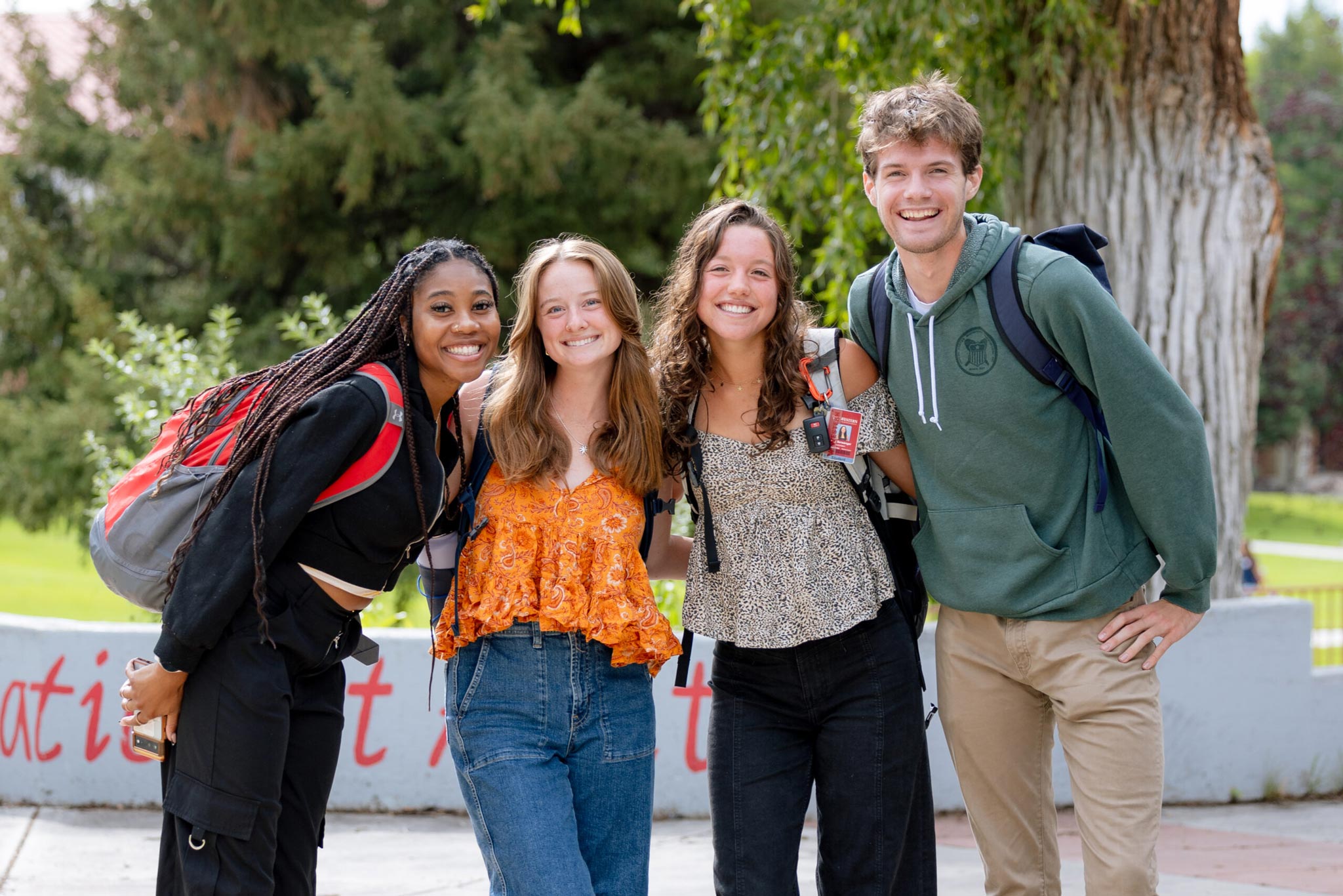 Four students gather for a group photo on their way to class.