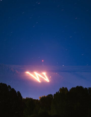 Seen from Van Tuyl Ranch, the collegiate "W" on Tenderfoot Mountain is lit on fire during the first night of Homecoming weekend.