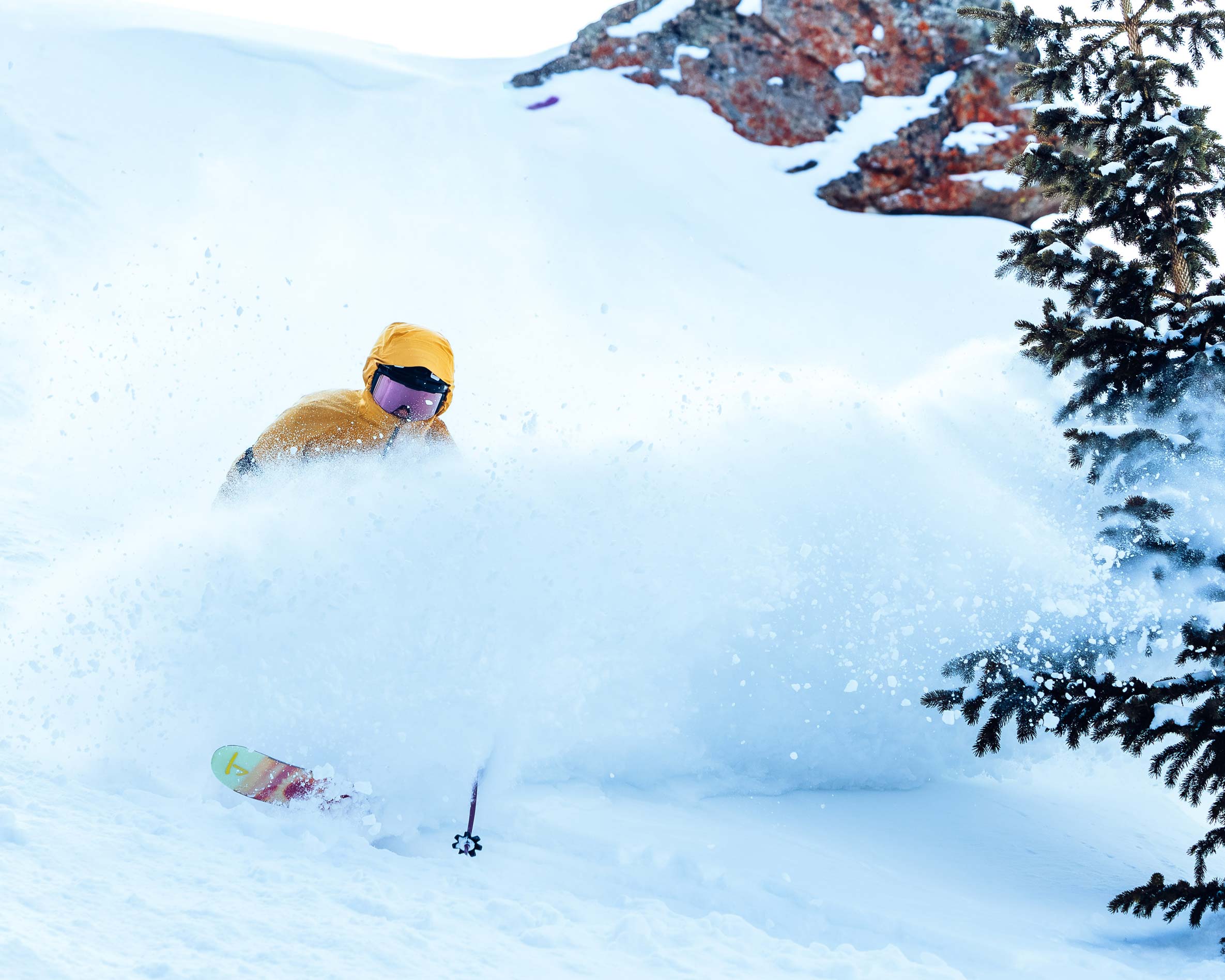 A skier skis through powder at Crested Butte Mountain Resort.
