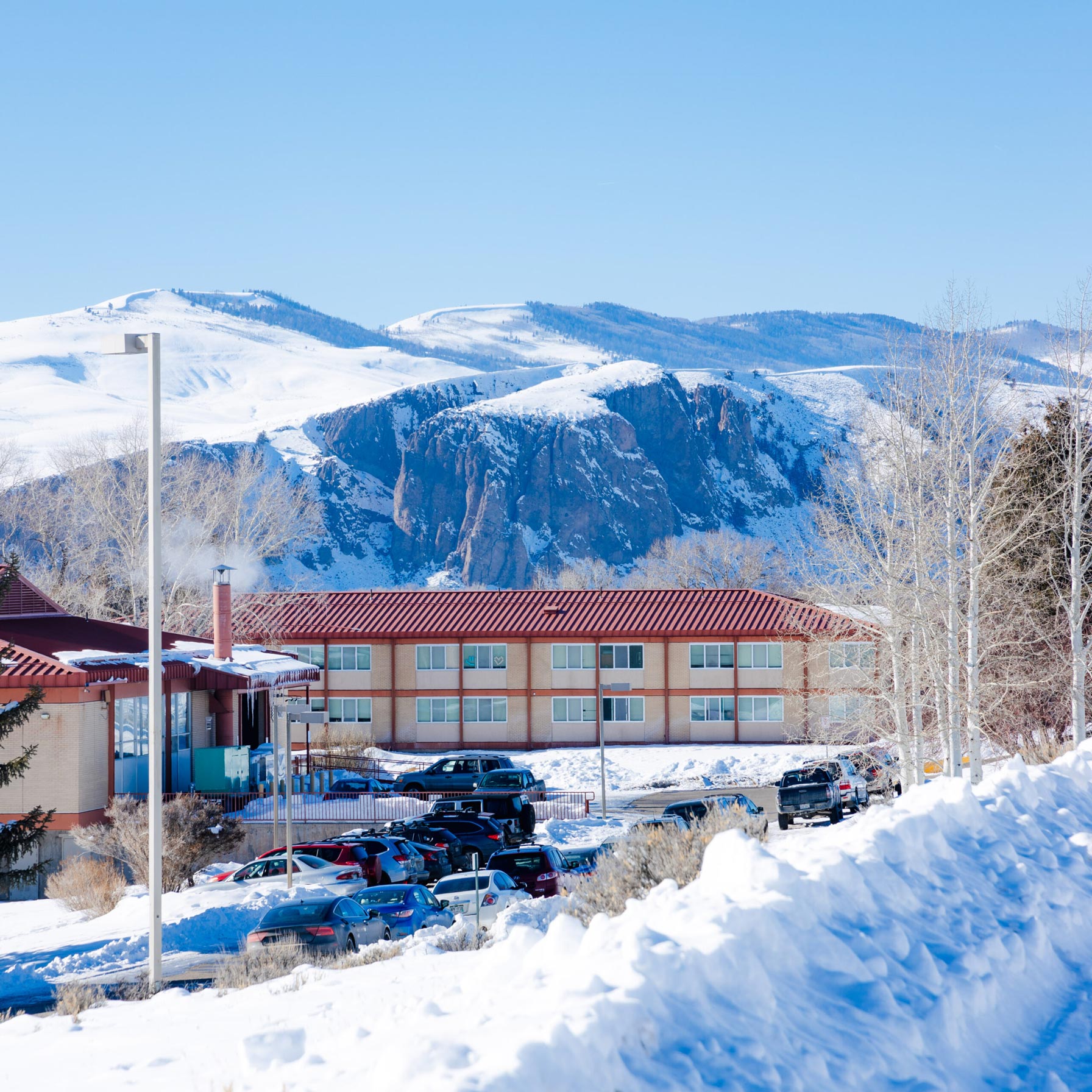 The Escalante Complex exterior in the winter with the Palisades in the background.