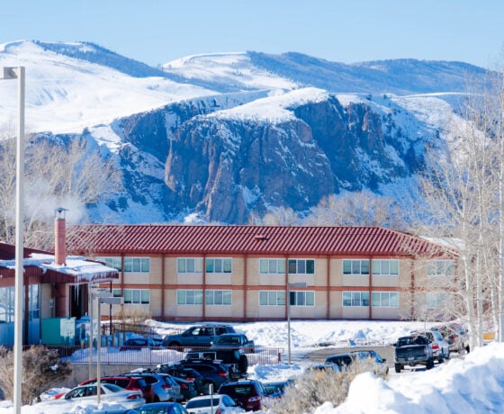 The Escalante Complex exterior in the winter with the Palisades in the background.