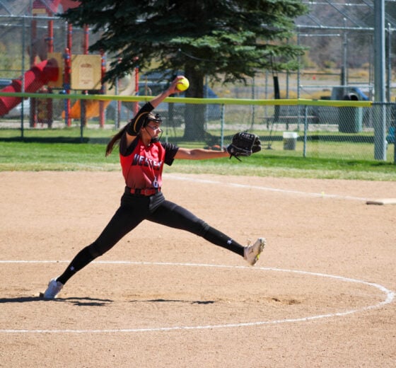 Softball player pitching #6 Anna Gallowich.