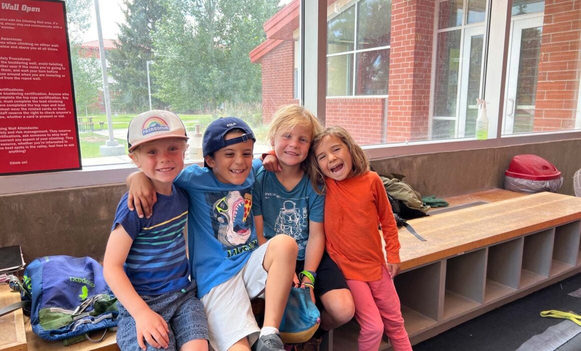 Four kids gather for a group photo inside the Mountaineer Field House.