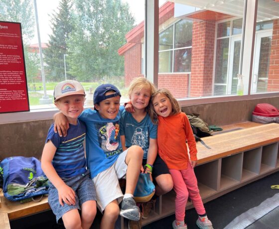 Four kids gather for a group photo inside the Mountaineer Field House.