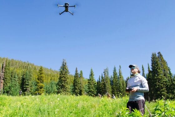 An MS Ecology student flies a drone during a class trip to Snodgrass.