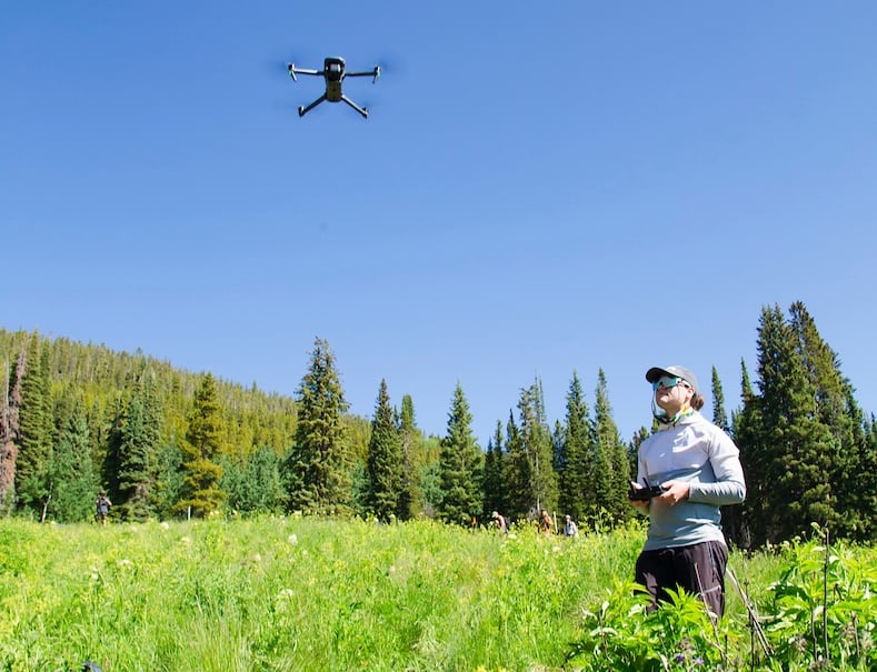 An MS Ecology student flies a drone during a class trip to Snodgrass.