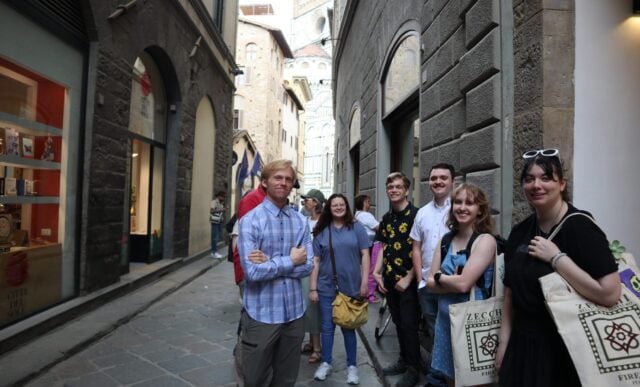 Group of art students outside of an art supply store on the streets of Florence, Italy