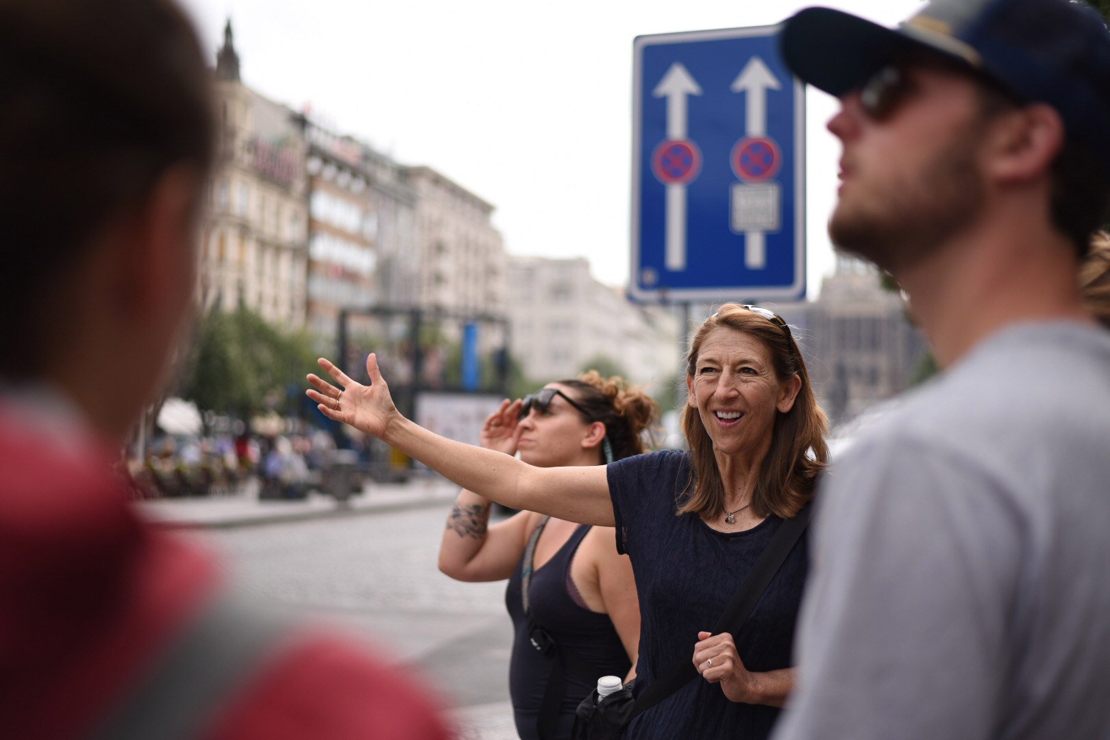A professor lectures to a study abroad class in the streets of Europe.