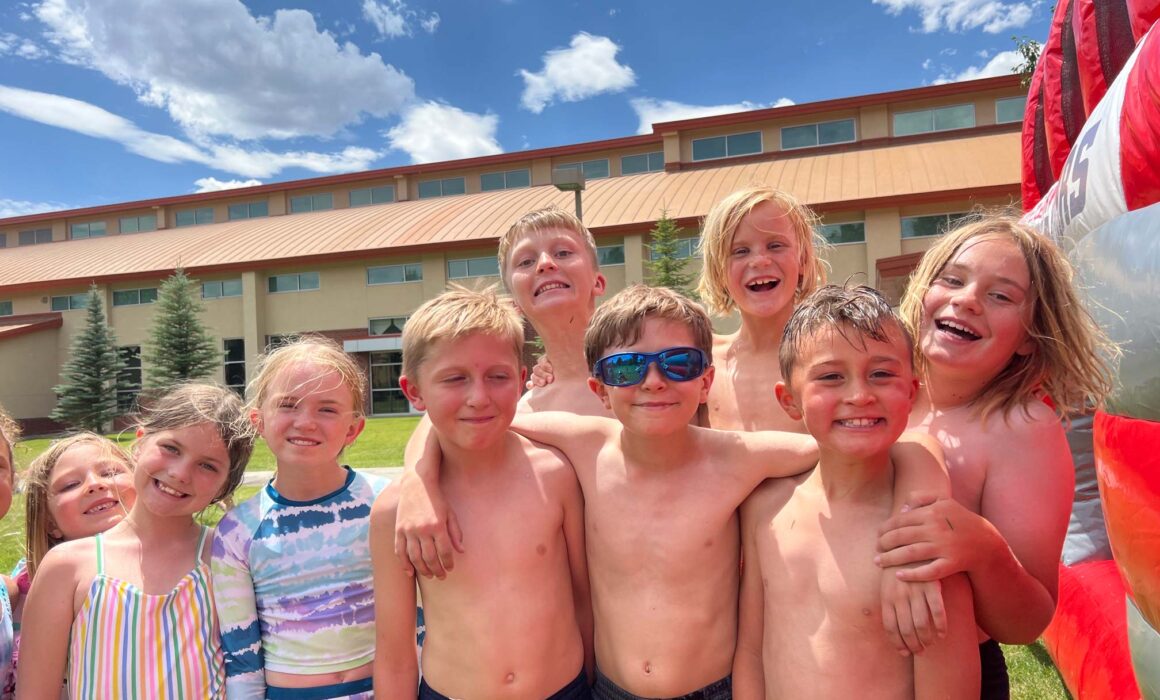 Group photo of kids in swimsuits at a Junior Mountaineers summer camp.